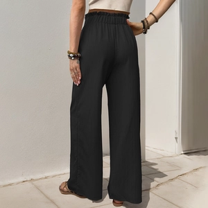 Women's casual high-waisted black wide-leg trousers with elastic ruffled waist and textured fabric