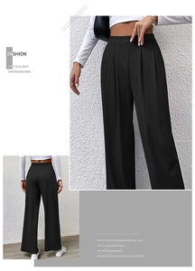 Detailed view of women's black high-waisted wide-leg trousers featuring pleated waist accents