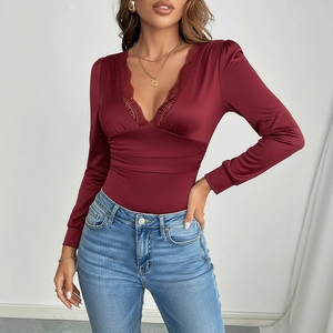 Detailed view of wine red satin bodysuit with delicate lace trim on deep V-neckline
