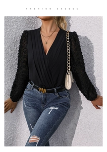 Detail of V-neck bodysuit with sheer feather mesh sleeves and cross-pleated bodice texture