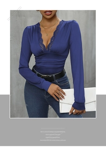 Detail of dark blue V-neck bodysuit featuring delicate lace trim and ruched waist design
