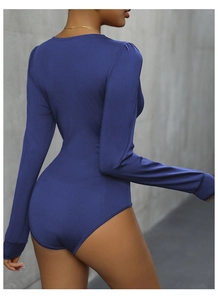Detail of slim-fit navy blue bodysuit showing elastic ribbed fabric and V-cut back design