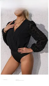 Detail of elegant black bodysuit with V-neck and textured 3D feather effect sleeves