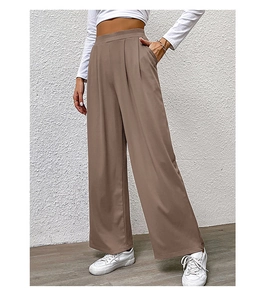 Detail view of high waisted brown wide leg trousers with pleated waist and side pockets