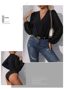 Detail of sheer puff sleeves with textured floral clusters on a black V-neck bodysuit