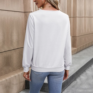 Women's minimalist white long sleeve sweatshirt with ribbed cuffs in an outdoor urban setting
