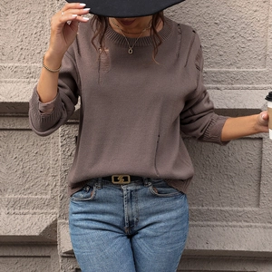 Brown distressed knit sweater with crew neck and hollow details in street style