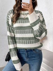Close-up of green and white striped knit sweater showing detailed ribbed texture and weave