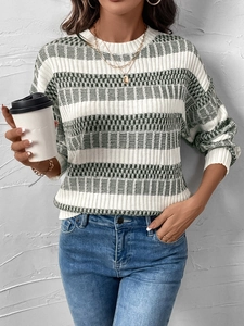 Detail of green and white striped knit sweater with textured geometric relief patterns