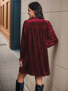 Détail du dos de la robe en velours bordeaux avec plis creux élégants et coupe évasée