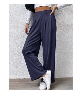 Detailed close-up of navy blue knit wide-leg pants with high elastic waist and pleats