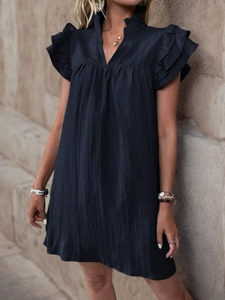 Close-up of navy blue summer dress showing the stand collar and vertical pleated texture