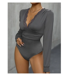 Detailed view of the deep V-neckline with delicate eyelash lace on a grey bodysuit