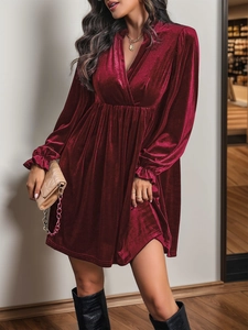 Détail de la robe en velours bordeaux avec décolleté en V profond et taille froncée