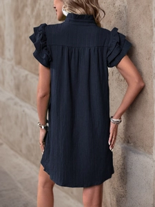 Detail view of tiered ruffle sleeves and textured fabric on a dark summer dress