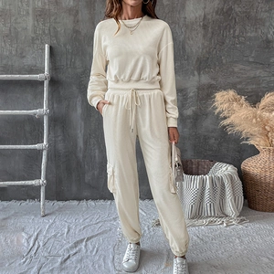 Detail of waffle textured beige two-piece set featuring long sleeve top and drawstring pants