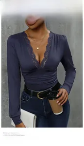 Close-up of the elegant deep blue bodysuit featuring intricate lace trim on a deep V-neckline