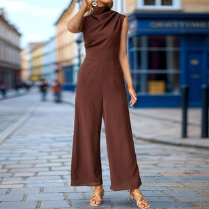 Detail of high-neck draped collar and sleeveless cut on dark brown wide-leg jumpsuit