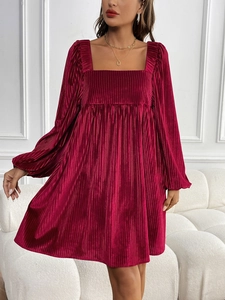 Macro detail of wine red velvet pleated fabric on long sleeve square neck dress