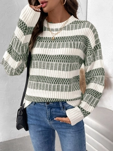 Close-up of green and white striped knit sweater with ribbed texture and crew neck
