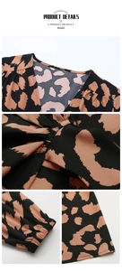 Detailed close-up of leopard print V-neckline, pleated waist, and elastic cuffs