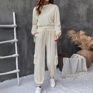 Detail of cream waffle texture two-piece set featuring cargo pockets and drawstring waist