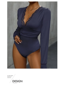 Detail of navy long sleeve bodysuit with deep V-neckline and delicate black lace trim