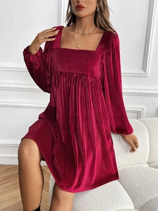 Detail of burgundy velvet mini dress with square neck and textured pleats
