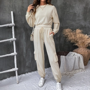 Detail of cream texture knit two-piece set featuring cargo pockets and high waist drawstring