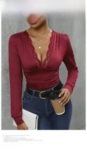 Detail of burgundy V-neck bodysuit with delicate lace trim and ruched waist design