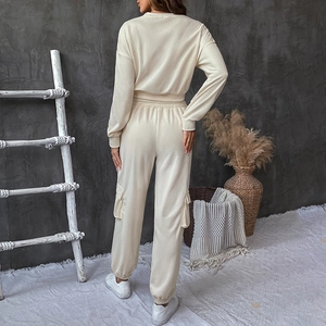 Rear view of a beige waffle knit two-piece lounge set with cargo pockets and relaxed fit
