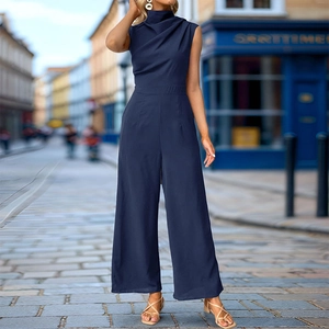 Detailed view of dark blue wide-leg jumpsuit with cowl neck and tailored waistline