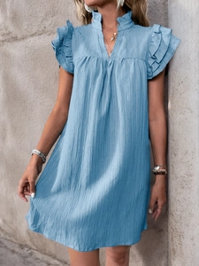 Close-up of light blue summer dress featuring a ruffled V-neck and layered ruffle sleeves