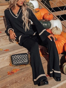 Women's 2-piece black knit set with V-neck top and wide-leg pants in autumn setting