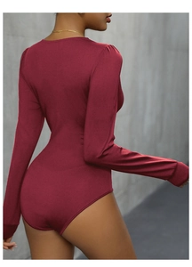 Detail of burgundy long sleeve bodysuit showing slim fit design and knit texture