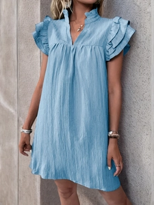 Detail view of light blue textured fabric with tiered ruffle sleeves on summer dress
