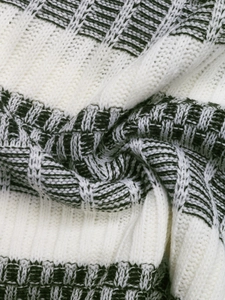 Detail of cream and dark green striped knit fabric showing thick texture and soft wool fibers