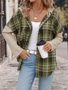 Close-up of green plaid hooded shirt featuring khaki waffle knit patchwork sleeves