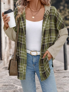 Detail of green plaid hooded shirt with beige waffle knit patchwork sleeves and buttons