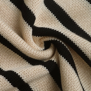 Close-up of high-quality black and white striped knitted fabric texture on the sweater