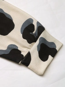 Close-up of ribbed cuffs on long sleeve hoodie with tricolor abstract pattern