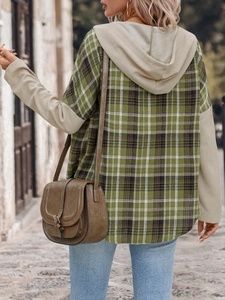 Detail of hooded plaid shirt featuring green checkered pattern and beige waffle knit sleeves