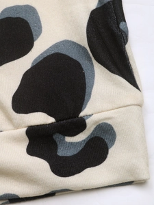 Macro shot of knit fabric texture with modern black, grey and beige patchwork patterns