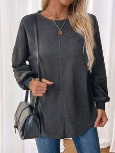 Detail of grey crewneck sweatshirt featuring a front seam design and square chest pocket