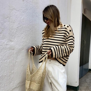 Women's chic black and white striped knit sweater with shoulder buttons and loose fit
