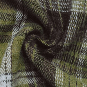 Detailed close-up of green and brown plaid fabric with textured herringbone weave