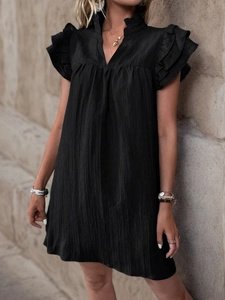 Detail of black pleated short sleeve dress featuring ruffle cuffs and a V-neckline