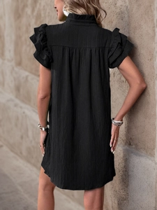 Detail of ruffle stand collar and layered flutter sleeves on a black summer dress