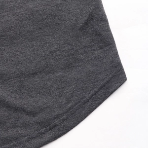 Detail of curved hem with double-needle stitching on dark gray knit sweatshirt