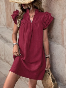 Detailed view of burgundy textured fabric and layered ruffle sleeves on summer dress